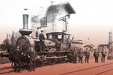 Historisk bild på ett ånglok och lokpersonal samt stationspersonal på Engelholm-Landskrona Järnväg. Foto.